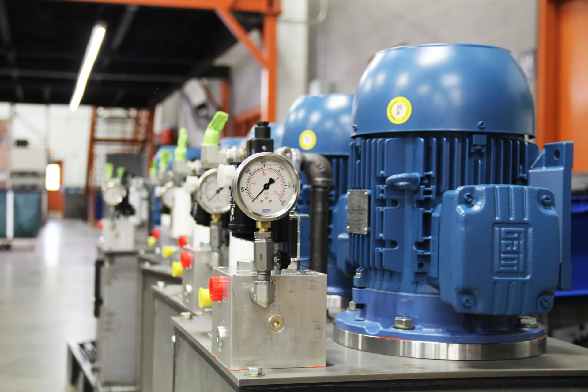 Row of MFP-built hydraulic power units with gauges and blue motors